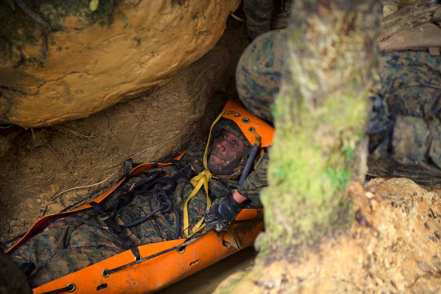 Marine Corps Lance Cpl. Daron Bush roleplays a simulated casualty at Camp Gonsalves, Okinawa, Japan, Feb. 16, 2018. Imagine having to get injured Marines through miles of caves to medevac within the golden hour.<br>(U.S. Marine Corps Lance Cpl. Jamin M. Powell)