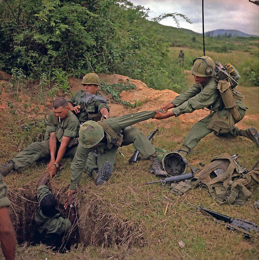 An Army infantryman is lowered into Vietnamese tunnels during a search-and-destroy mission in Vietnam, 1967.<br>(U.S. Army photo by Staff Sgt. Howard C. Breedlove)