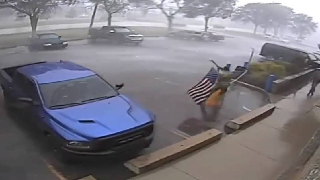 Watch as these soldiers rush into a storm to pick up a fallen flag