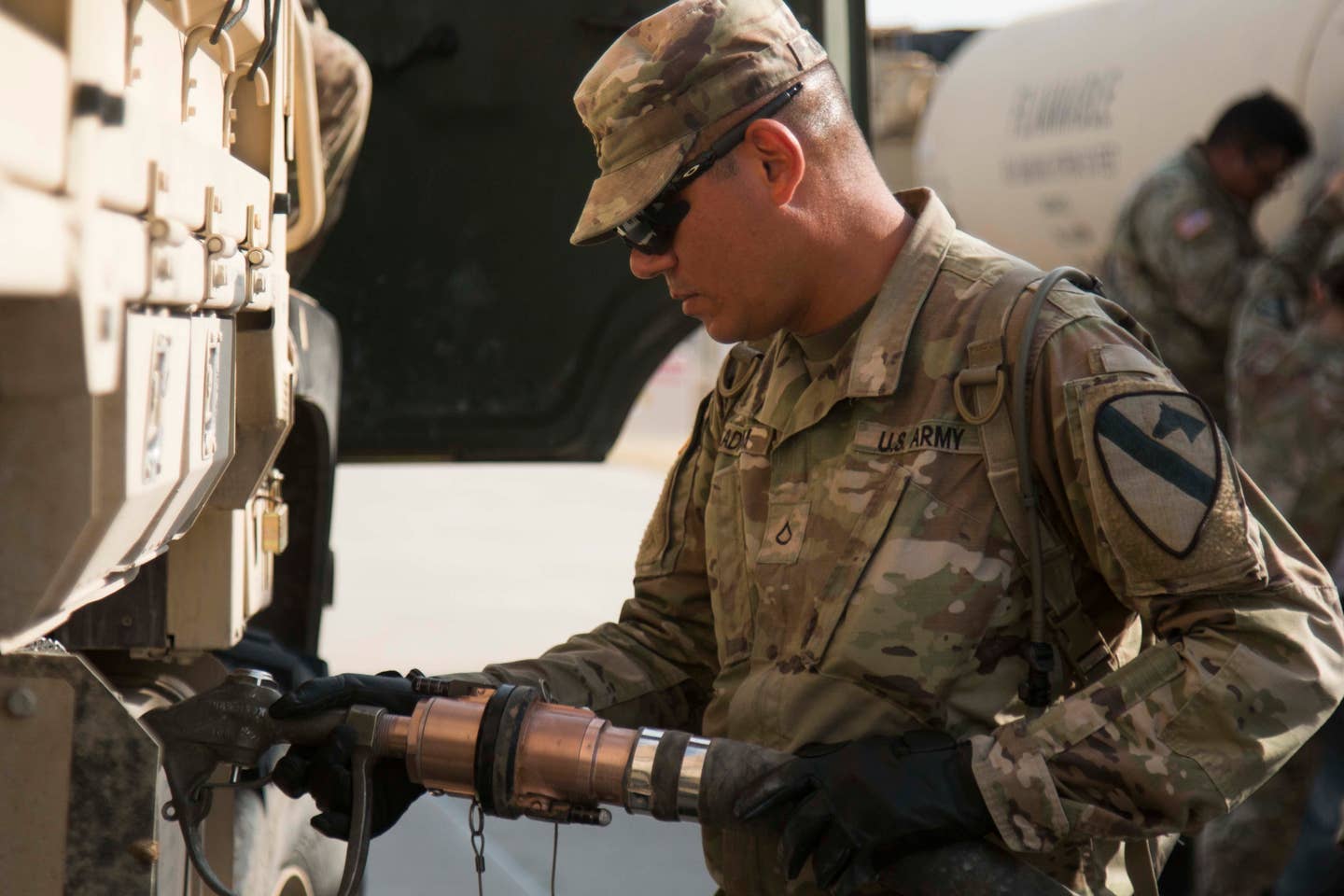An Iraqi-American soldier refuels vehicles during a drivers training class.<br>(U.S. Army photo by Sgt. Jessica DuVernay)