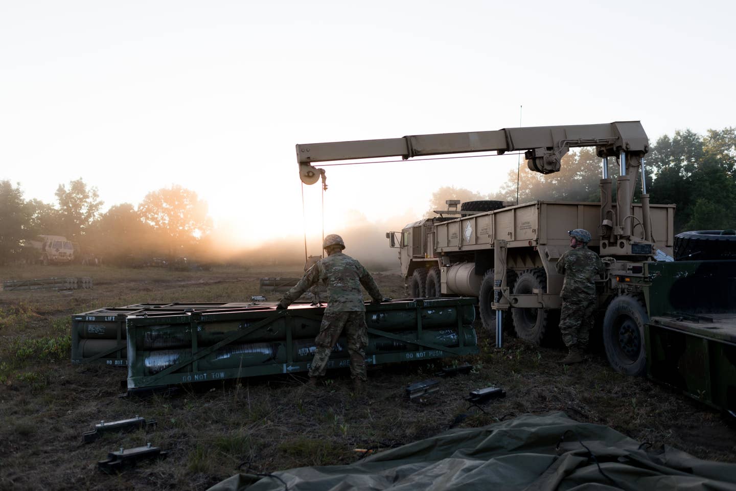 Truck drivers load ammo during an exercise.<br>(U.S. Army photo by Spc. Joshua Boisvert)