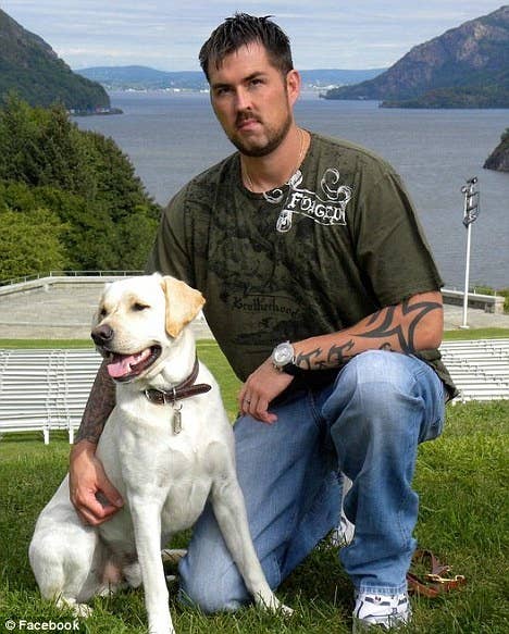 Marcuss Luttrell poses with his golden retriever, rigby