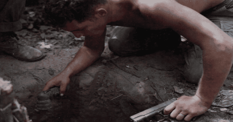 Sgt. Ronald H. Payne, a "tunnel rat", bravely searches a tunnel's entrance during Vietnam War