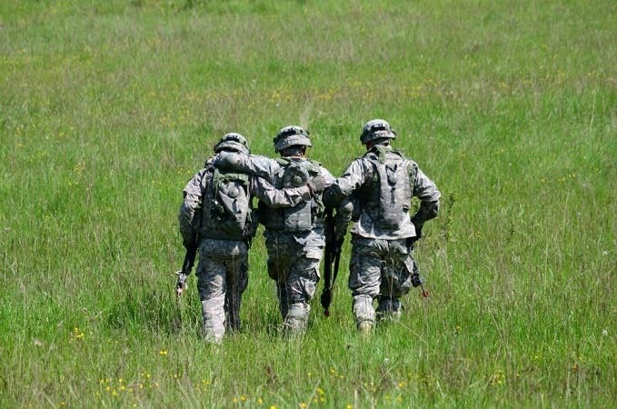 Three soldiers walking together. Usually, the buddy system works in pairs