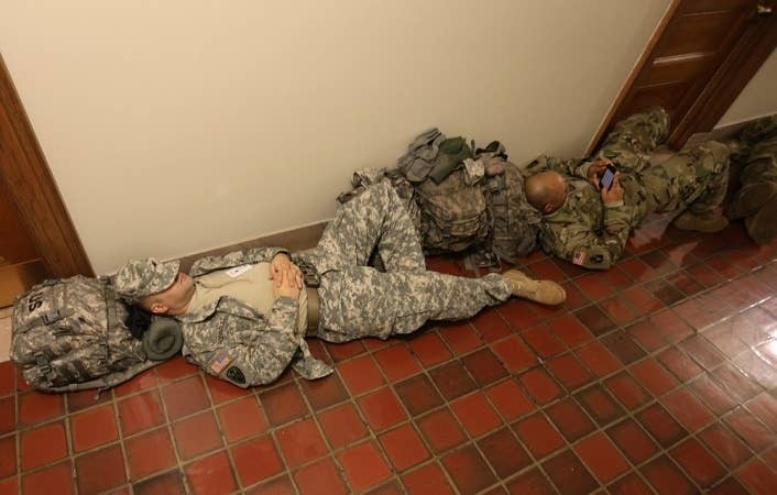 Soldiers sleeping in a hall. Maybe a blue falcon locked them out