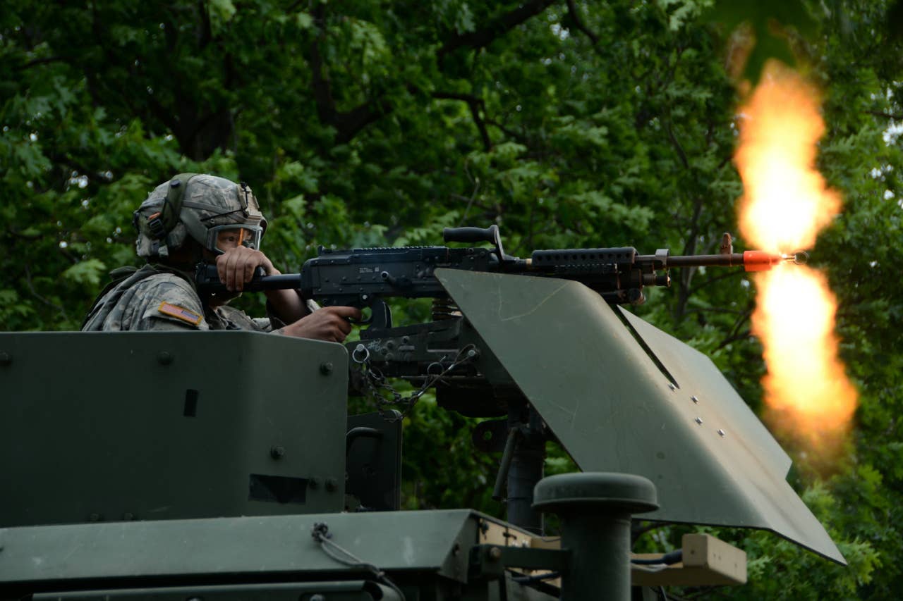 A soldier fires the M240B during an exercise. The M240B fires a 7.62mm round that carries more energy than a 5.56mm NATO rounds, but still much less than the .50-cal. machine gun. The amount of kinetic energy in a round is largely a product of its propellant and its mass. (U.S. Army National Guard Spc. Andrew Valenza)