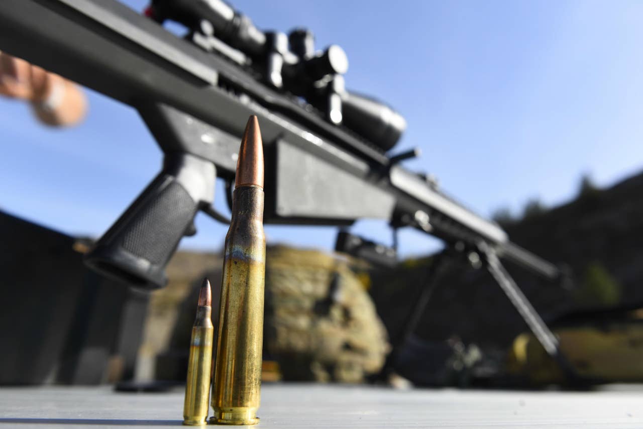 A 5.56mm NATO round stands to the left of a .50-cal. sniper round. (U.S. Air Force Airman 1st Class Lawrence Sena)