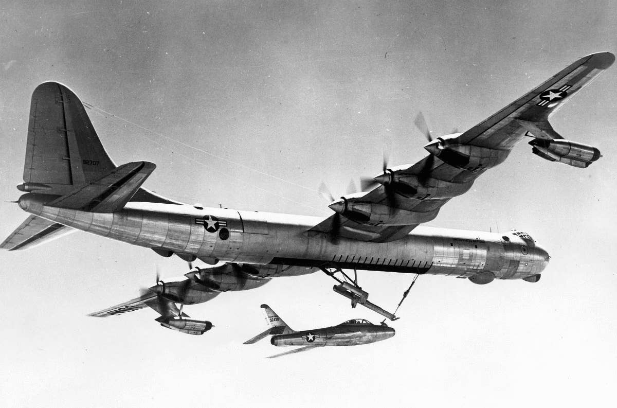 A YRF-84F fighter in flight with its parent B-36 Peacemaker.<br>(U.S. Air Force)