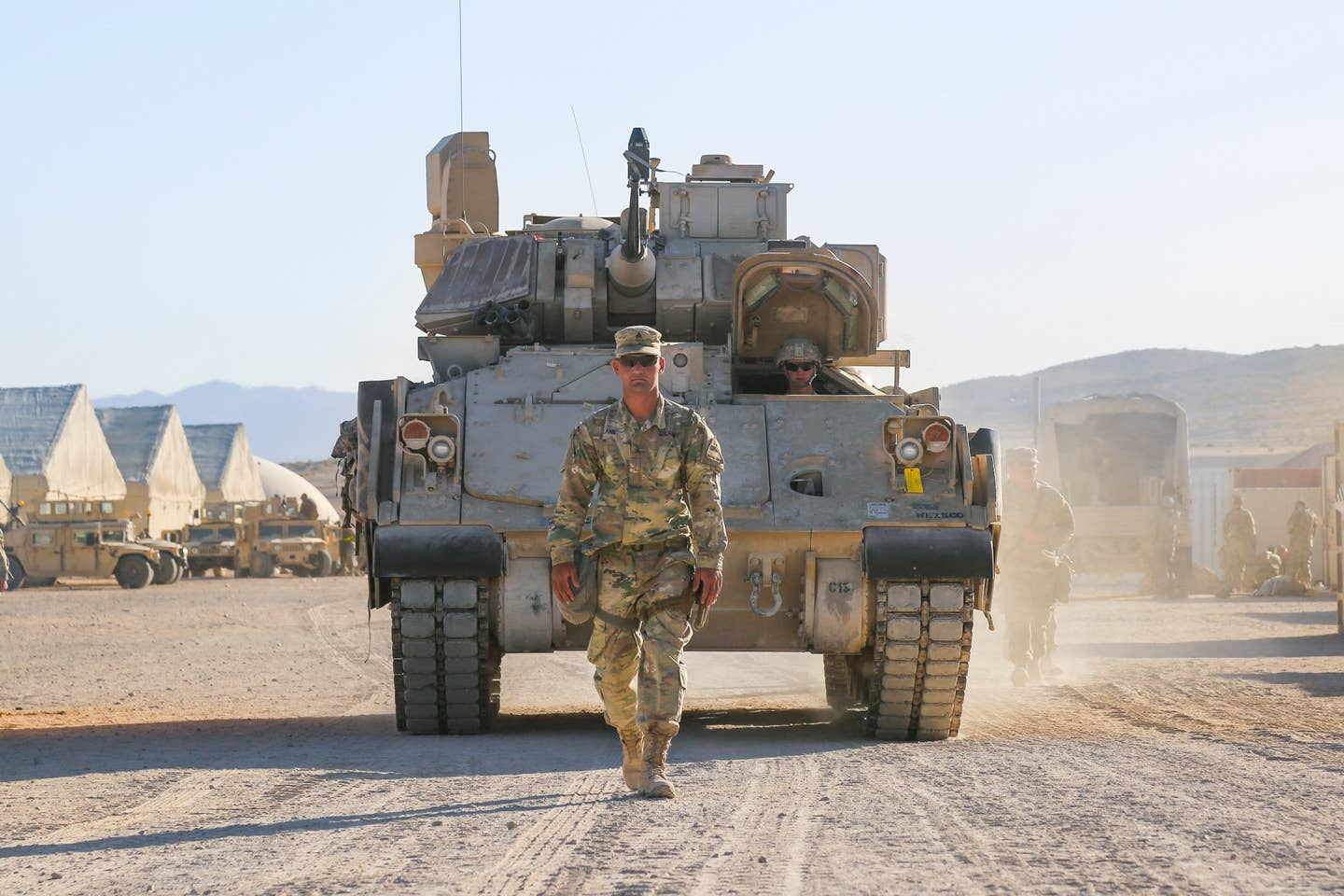 A U.S. Army Soldier assigned to 3rd Armored Brigade Combat Team, 1st Armored Division, Fort Bliss, Texas, ground guides an M2 Bradley Infantry Fighting Vehicle.<br>(U.S. Army Spc. Esmeralda Cervantes)