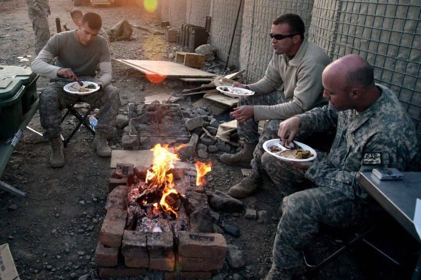 Soldiers share a meal and, likely, gossip. Having a couple of lower enlisted people advocating for you in the rumor mills can be essential. (U.S. Army Staff Sgt. Andrew Smith)