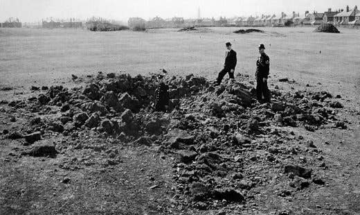 A bomb crater from a German bomb hit a field during the Blitz.