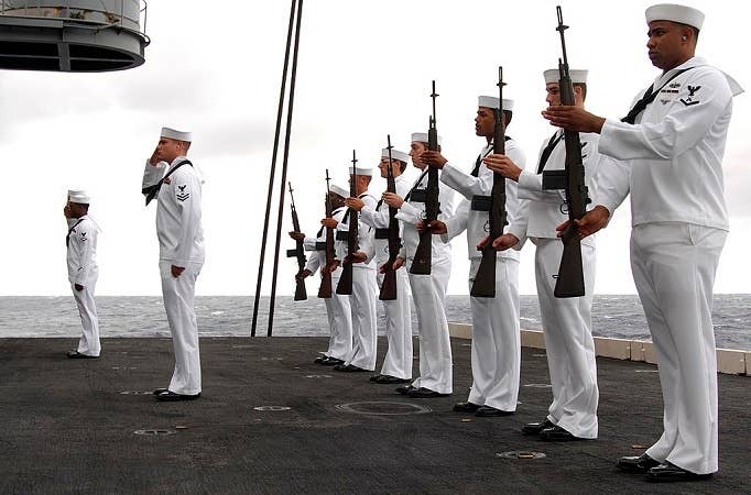 If you're going to salute in combat, you're wrong. If you're going to salute with a rifle and it doesn't look like the above photo, you're even more wrong. (U.S. Navy photo by Mass Communication Specialist 3rd Class Damian Martinez)