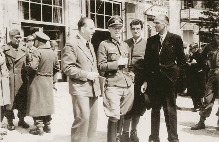 Colonel Bogislaw von Bonin (center) with fellow hostage and British intelligence officer Sigismund Payne Best (dark suit right) shortly after liberation by the United States on 5 May 1945.