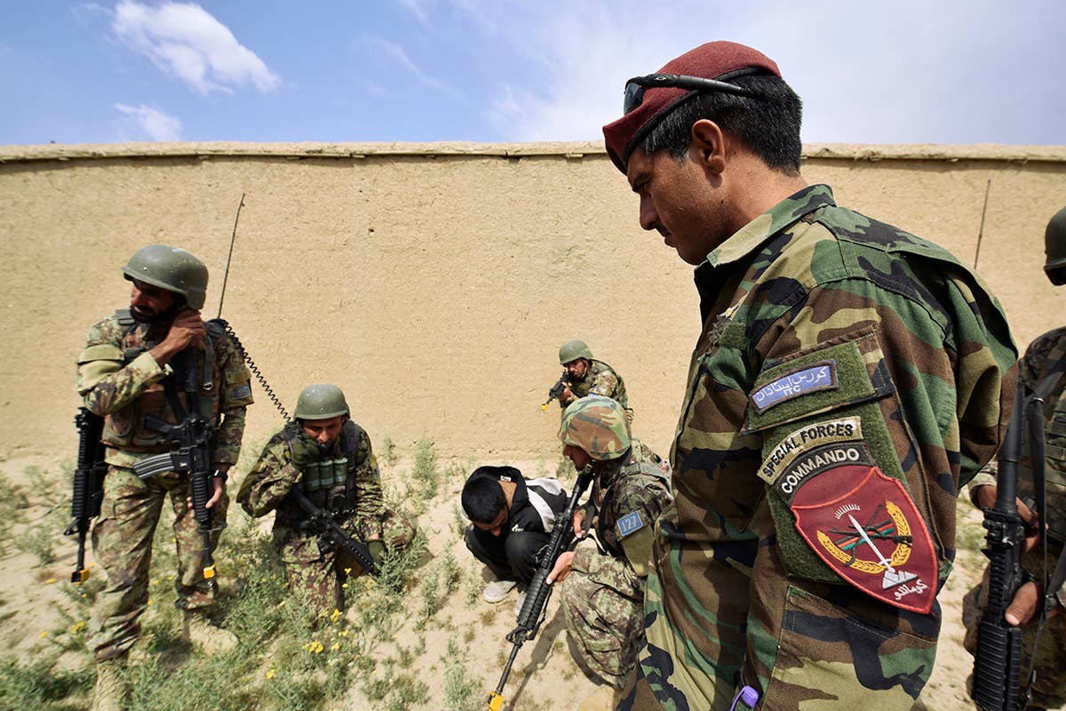 An Afghan National Army Special Operations Commando instructor assesses Commando recruits in training as they perform security duties during a training exercise in Camp Commando, Kabul, Afghanistan, May 6, 2018. (U.S. Army Master Sgt. Felix Figueroa)