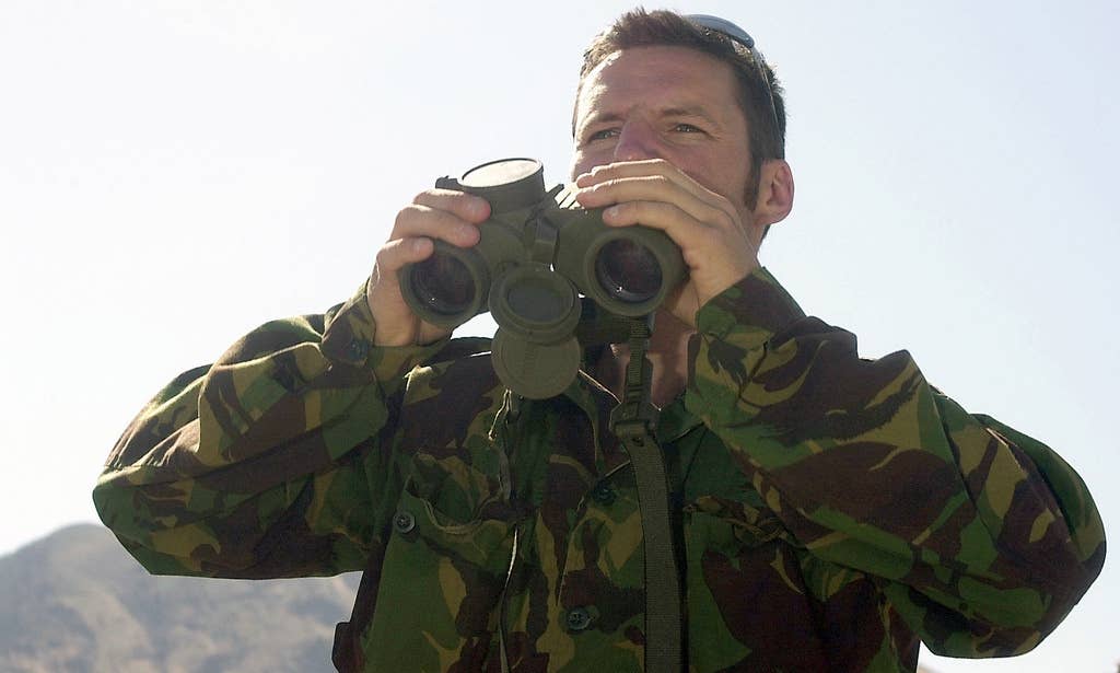 A British Special Forces member from the 22nd Special Air Service at Hereford, England, uses binoculars to locate a target down range. (U.S. Air Force Senior Airman Rick Bloom)