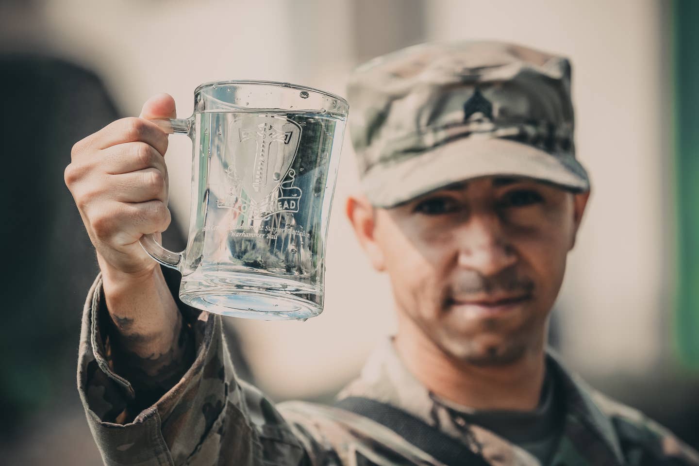 Please don't let that be a mug of vodka. I mean, I know the dude in the photo is a sergeant and is experienced enough to handle it, but still. (For the record, it's a water guy holding a mug of water.) (U.S. Army Spc. Aaron Goode)