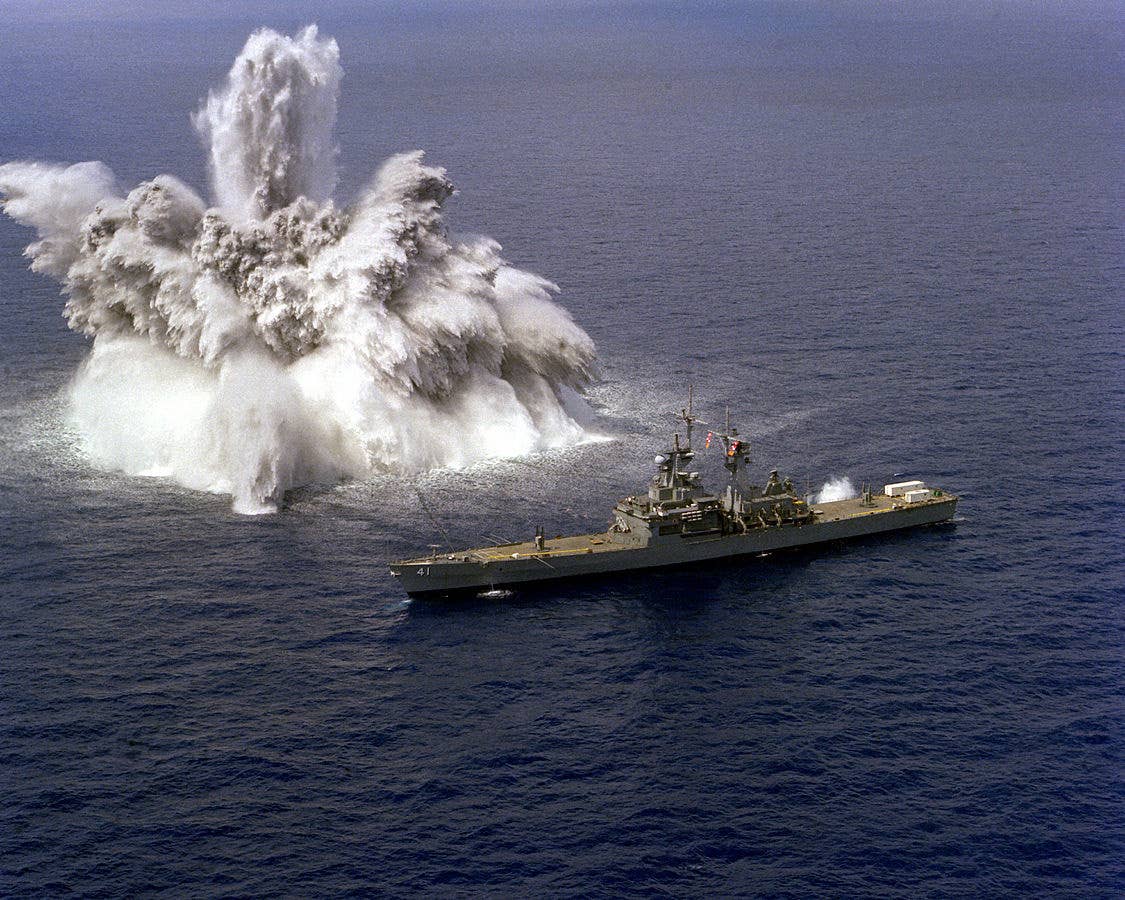 The Navy detonates an explosive charge off the starboard side of the USS Arkansas, a nuclear-powered cruiser, during sea trials. (U.S. Navy Photographer's Mate 1st Class Toon)