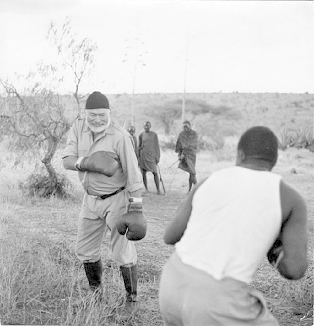 Hemingway sparring with locals in Africa.