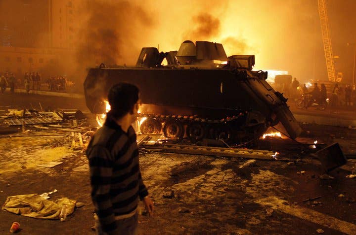 An armored personnel carrier burns in the streets of Egypt during 2011 protests. (Amr Farouq Mohammed, CC BY-SA 2.0)