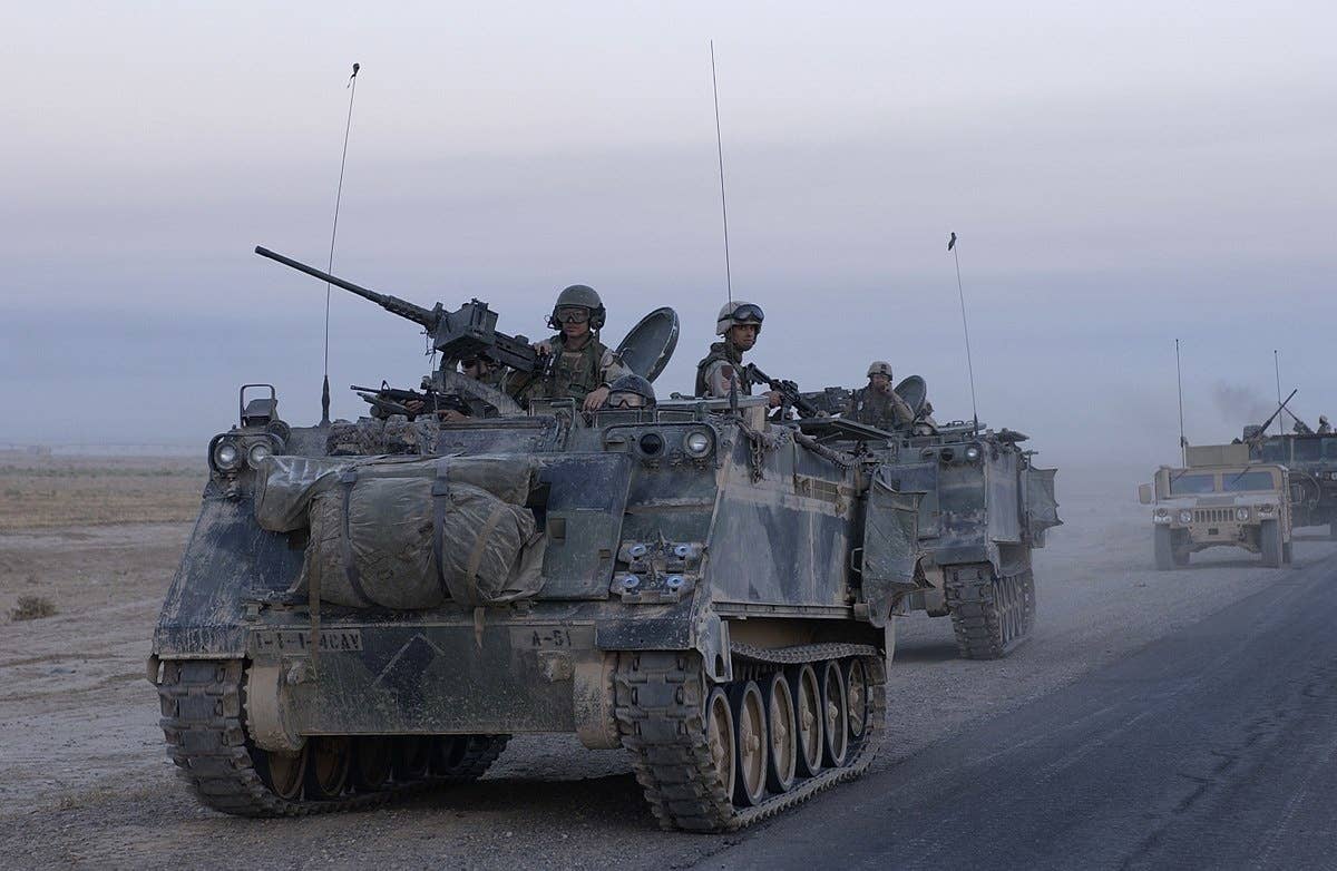U.S. Army armored vehicles leave Samarra, Iraq, after conducting an assault on Oct. 1, 2004. (U.S. Army Staff Sgt. Shane A. Cuomo)