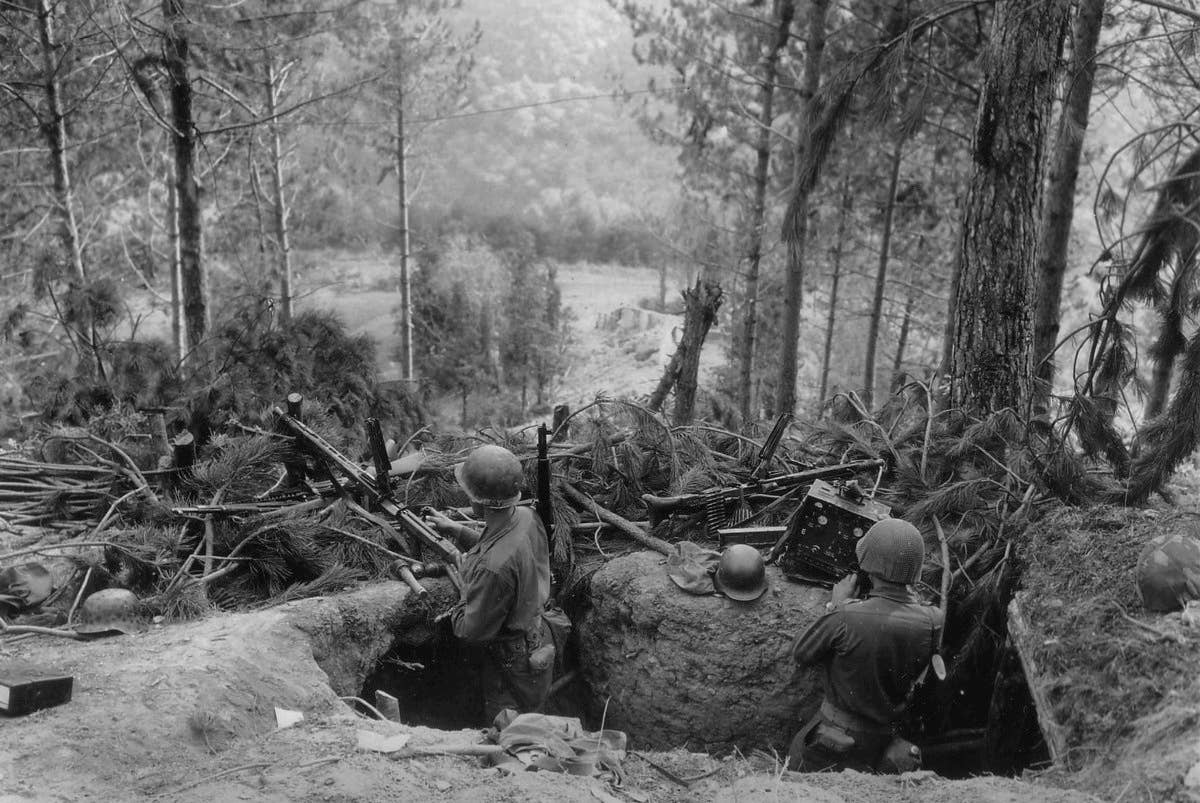 American troops man a machine gun in a captured German position during the 1944 Battle of Hurtgen Forest.