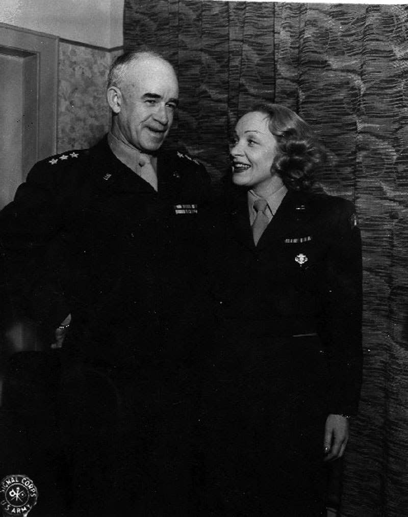 Lt. Gen. Omar Bradley poses with actor Marlene Dietrich during a USO tour during World War II. (U.S. Army)
