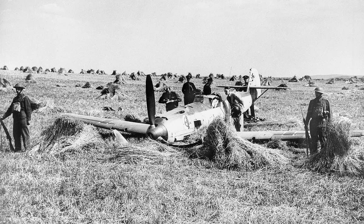British troops guard a downed German Messerschmitt Bf 109 in August 1940. Radar helped British pilots hold off German advances despite a shortage of pilots and planes. (Imperial War Museums)