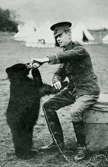 Harry Colebourne and Winnipeg the Bear when Winnie was still young. (Manitoba Provincial Archives)