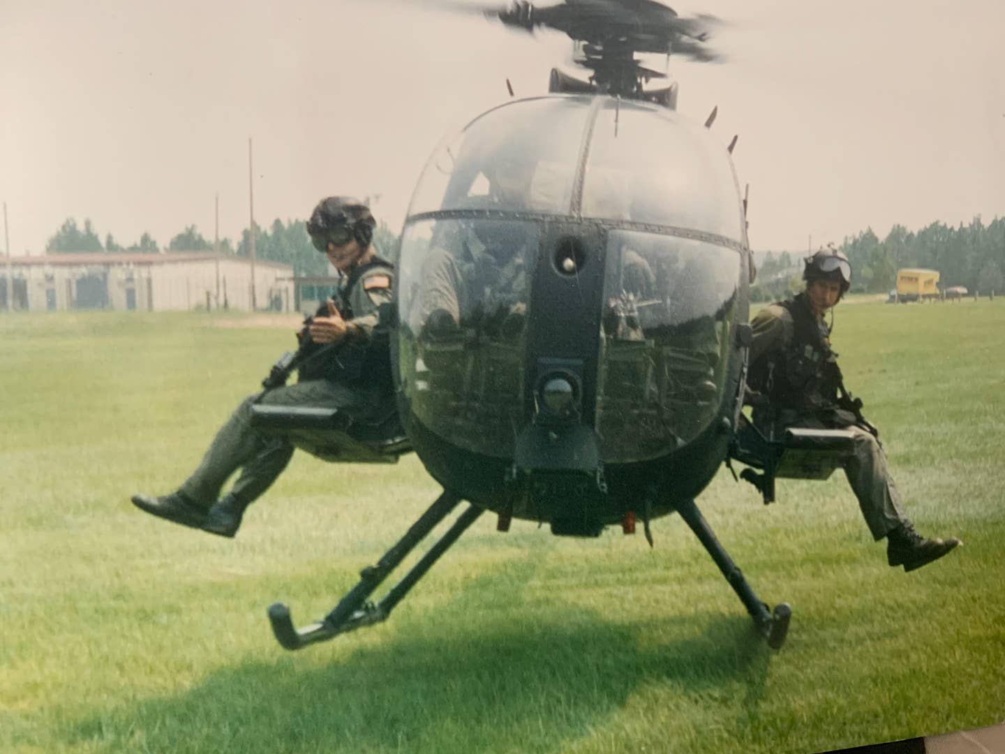 (The author on left and teammate on right, lift off with an MH-6 for more gun runs, not giving one-tenth of a rat's ass about the temperature of the shrimp platter. (Photo courtesy of SMU Operator MSG Gaetano Cutino, KIA)