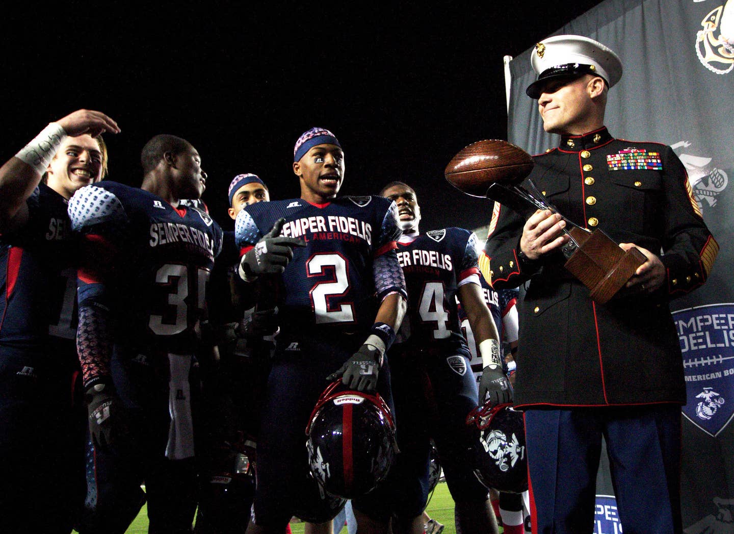 The things we do to have a Sergeant Major hand us a wooden football. (U.S. Marine Corps photo by Sgt. Scott Schmidt)