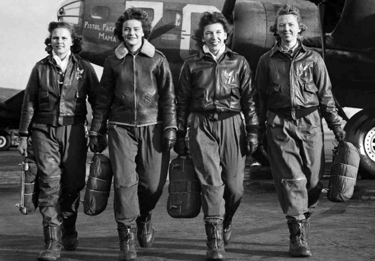 WASP (from left) Frances Green, Margaret Kirchner, Ann Waldner and Blanche Osborn leave their B-17, called Pistol Packin' Mama, during ferry training at Lockbourne Army Air Force base in Ohio. They're carrying their parachutes.<br>(National Archives)
