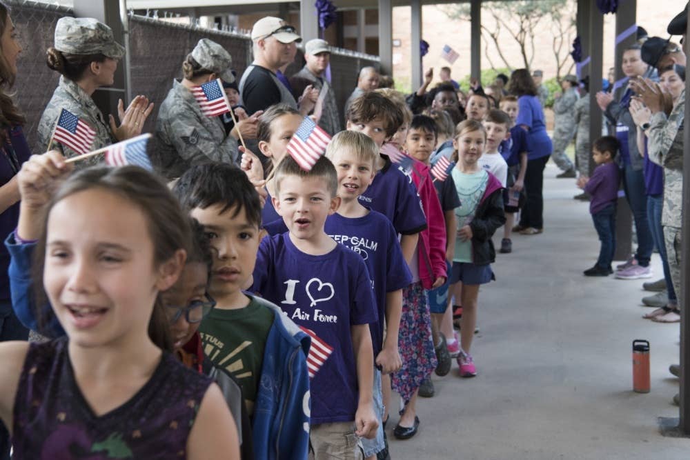 Students at Lackland Independent School District march and cheer during the PurpleUp! Parade April 12, 2019, at Joint Base San Antonio-Lackland, Texas. The parade was held in honor of the Month of the Military Child. April was designated as the Month of the Military Child in 1986 to recognize the sacrifices children in military families make along with the challenges they face. U.S. Air Force/Krystal Wright