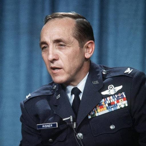 <em>Risner answers questions at a press conference after he is released from captivity. (Photo by the United States Air Force)</em>