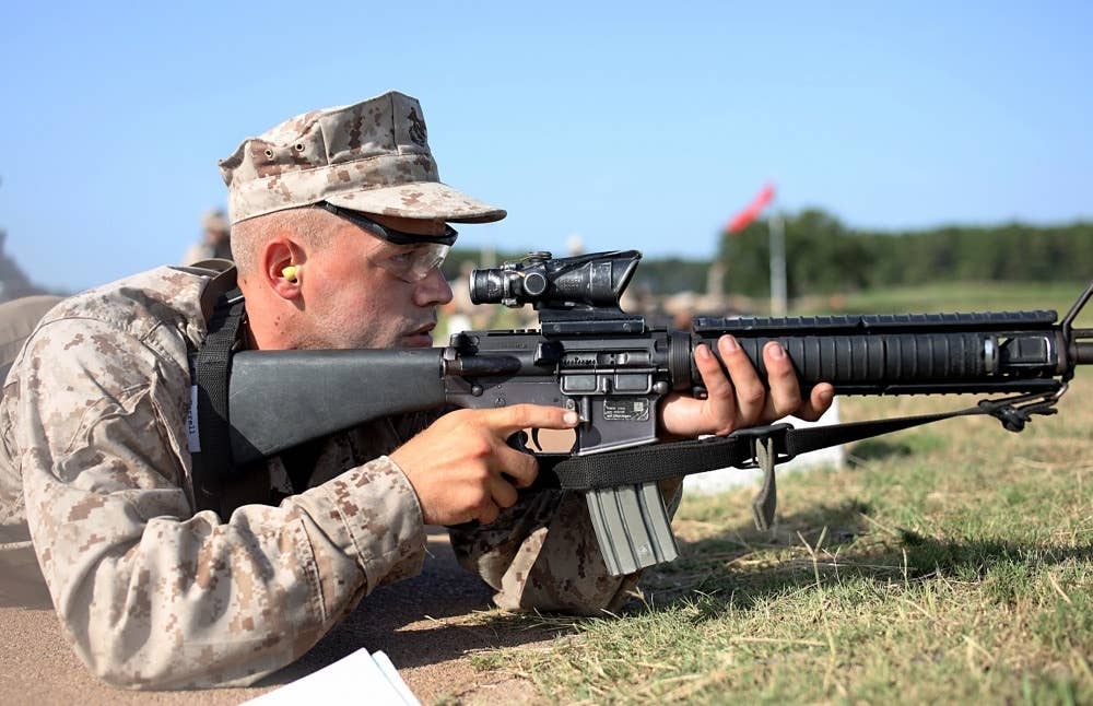 <em>Recruit Austin Ferrell with Kilo Company, 3rd Recruit Training Battalion fires his M16A4 Service Rifle during the Table One course of fire on Marine Corps Recruit Depot, Parris Island S.C. July 30, 2020. (U.S. Marine Corps photo by Cpl. Shane Manson)</em>