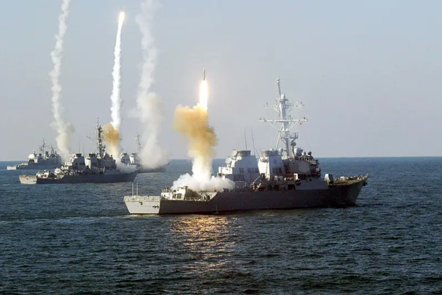 <em>Left to right, the guided missile cruiser USS Vicksburg (CG 69), and the guided missile destroyers USS Roosevelt (DDG 80), USS Carney (DDG 64) and USS The Sullivans (DDG 68) launch a coordinated volley of missiles during a Vandel Exercise (VANDALEX). (US Navy photo)</em>