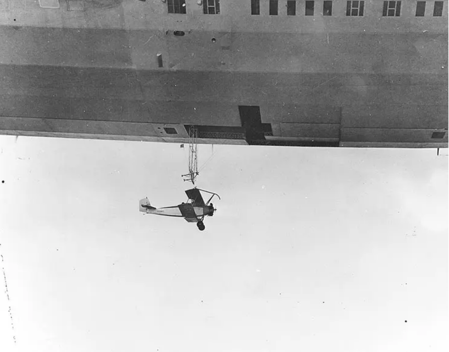 USS Akron (ZRS-4) Launches a Consolidated N2Y-1 training plane (Bureau # A8604) during flight tests near Naval Air Station Lakehurst, New Jersey, 4 May 1932. (U.S. Navy)