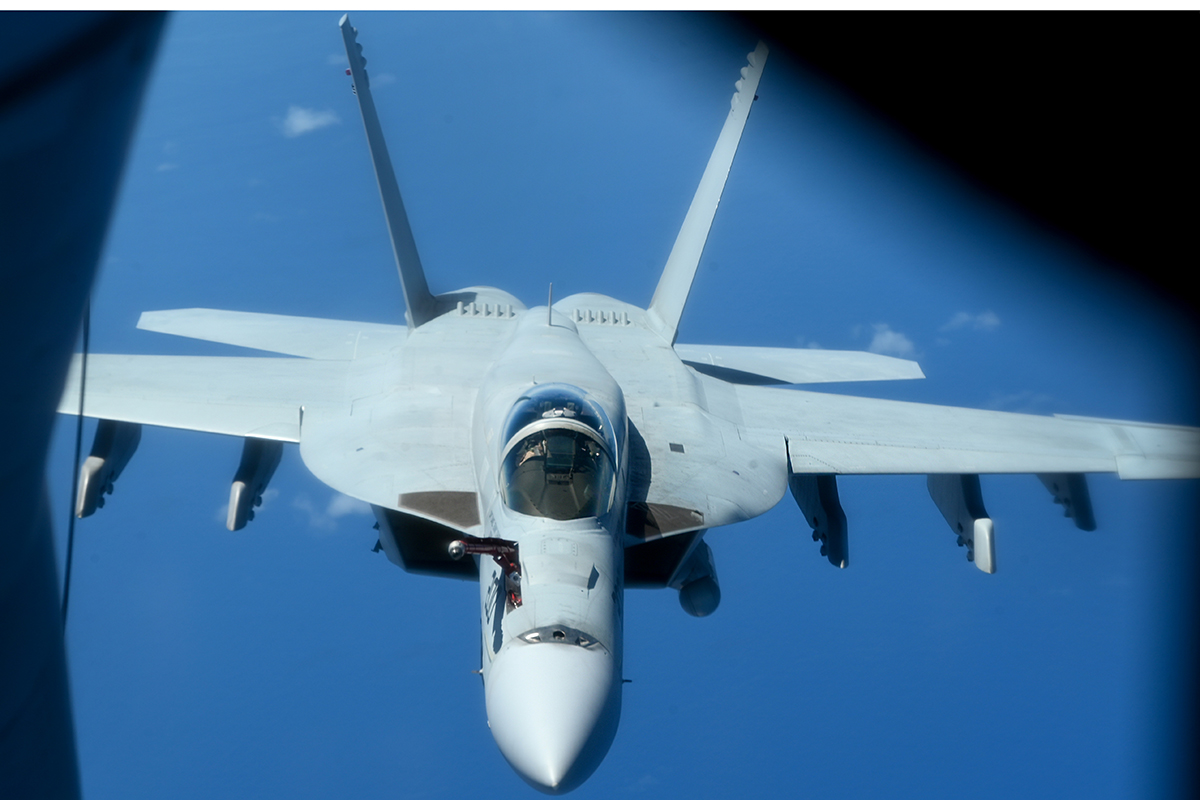 A U.S. Navy EA-18G Growler assigned to Electronic Attack Squadron 131 approaches a KC-135 Stratotanker from the 909th Air Refueling Squadron during a large force exercise over the Pacific Ocean, Aug. 26, 2025. The Growler, built to replace the EA-6B Prowler, is the first newly designed electronic warfare aircraft produced in more than 35 years. (U.S. Air Force photo by Staff Sgt. Gary Hilton)