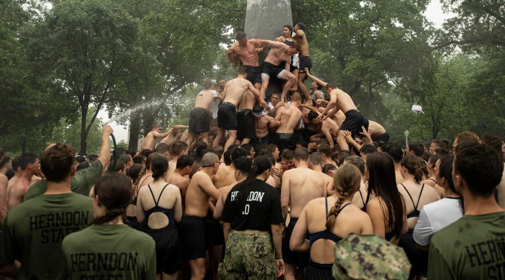U.S. Naval Academy plebes climb the Herndon Monument to commemorate their freshman year. weird military traditions The Herndon Monument Climb usna
