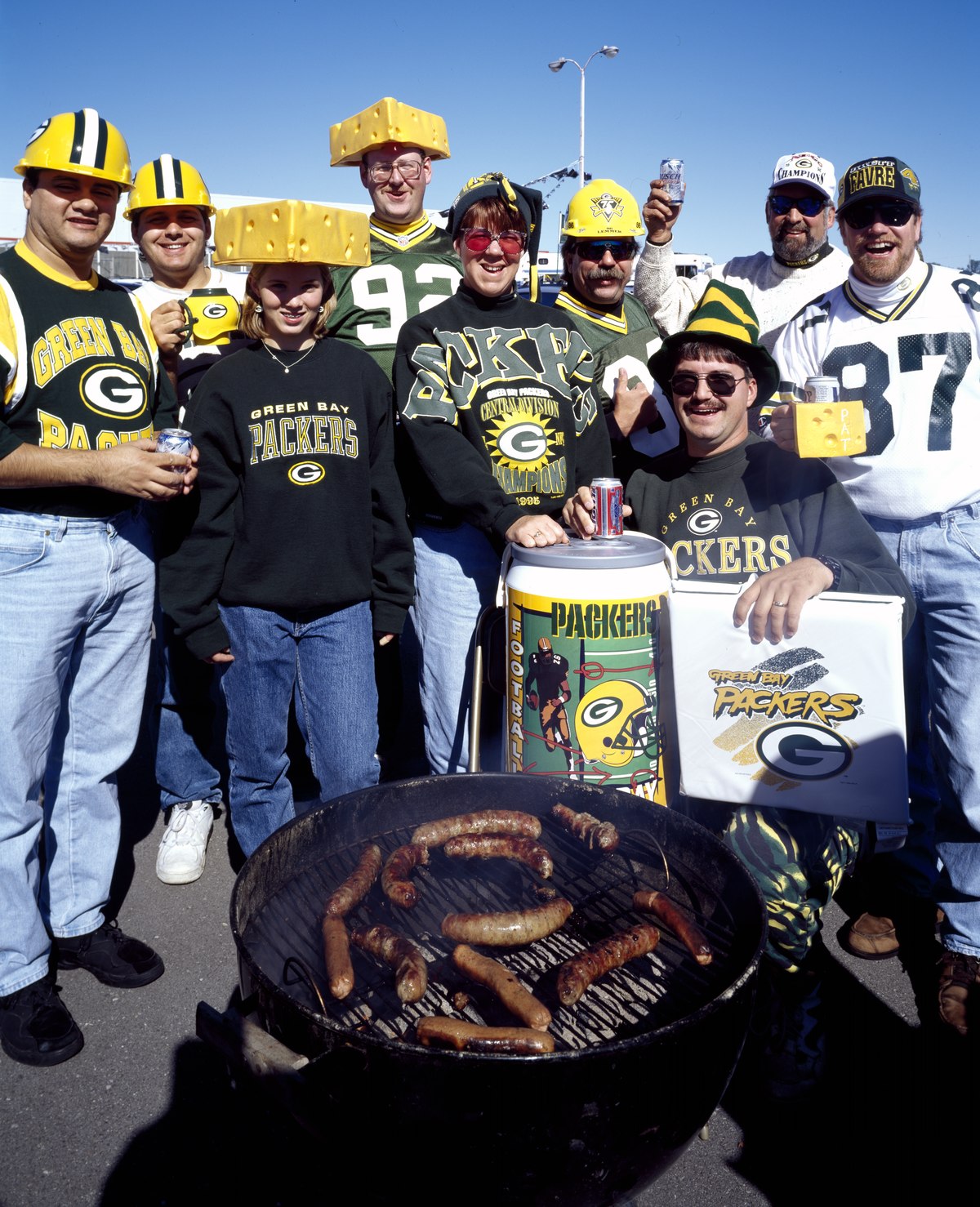 Fans in NFL merchandise, cheering on the Green Bay Packers