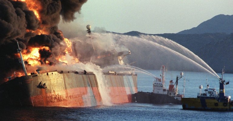 tanker war ship on fire hormuz getty