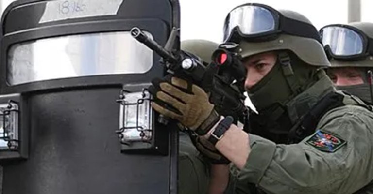 A ballistic shield with a clear armored viewing port and spotlights. (U.S. Marine Corps)