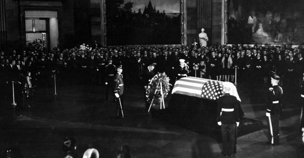 President Lyndon B. Johnson placing a wreath before the flag-draped casket of President John F. Kennedy in the Capitol rotunda. (National Archives)