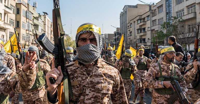 Basiji militants march while holding AK-47 rifles during a parade of an alleged 110,000 paramilitary Basij and IRGC (Islamic Revolutionary Guard Corps) forces in downtown Tehran, Iran, on January 10, 2025. (Photo by Hossein Beris / Middle East Images / Middle East Images via AFP) (Photo by HOSSEIN BERIS/Middle East Images/AFP via Getty Images)