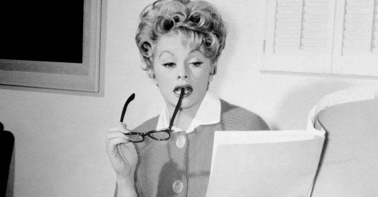 Lucille Ball (1911-1989), US comedian and actress, holding eyeglasses and script,