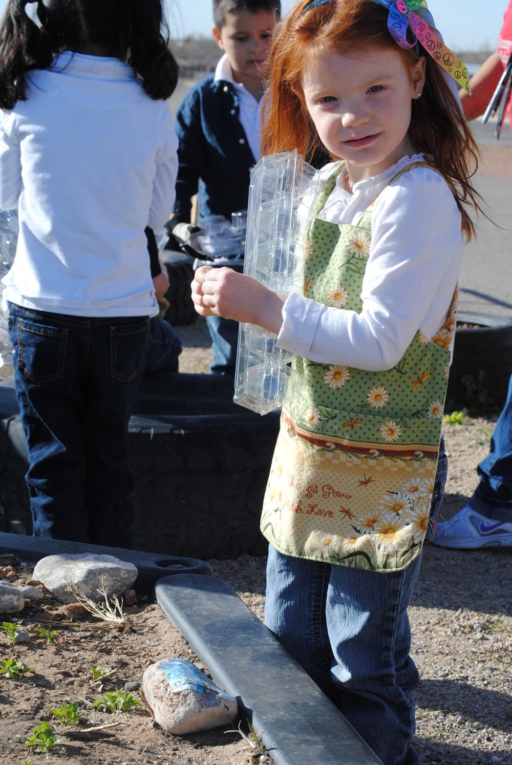 Keira Stokes prepares to plant seeds into a recycled egg crate at the Logan Heights Child Development Center here Feb. 24, 2012. The location features a classroom-run garden with vegetables and flowers grown from composted soil.