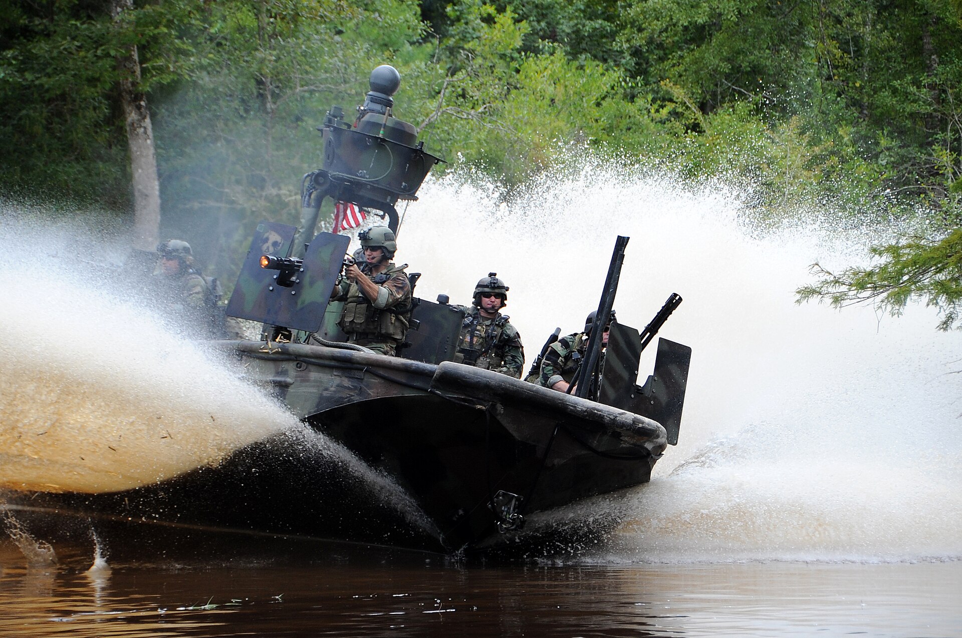 JOHN C STENNIS SPACE CENTER, Miss. (Aug. 16, 2009) – Special Warfare Combatant-craft Crewmen (SWCC) from Special Boat Team 22 drive a Special Operations Craft-Riverine (SOC-R) for a scene in the upcoming Bandito Brothers production tentatively titled “I Am That Man”, due in theaters in 2010. SWCC are U.S. Special Operations Command maritime mobility experts. (U.S. Navy photo by Chief Mass Communication Specialist Kathryn Whittenberger/Released)