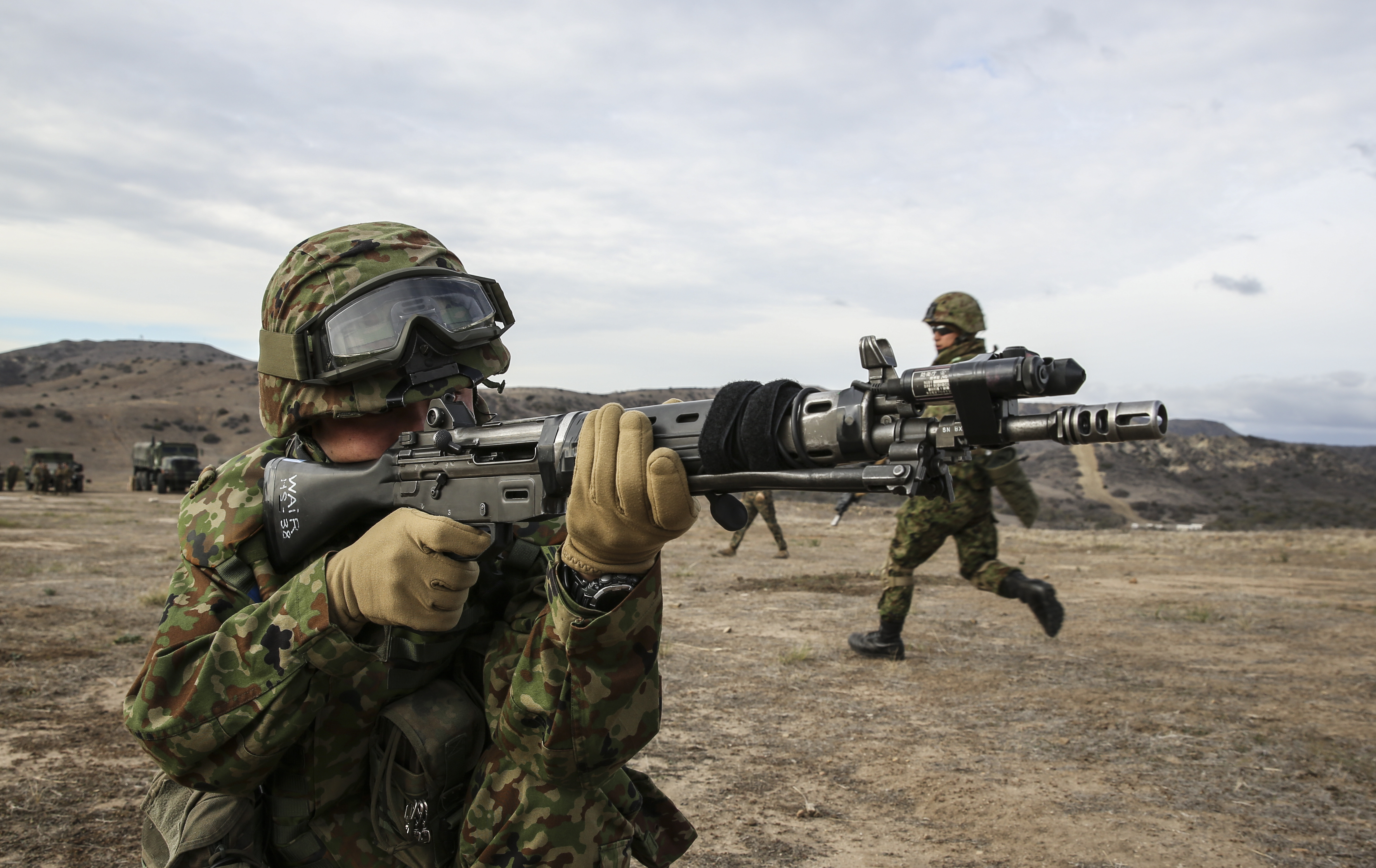 A soldier from the Japan Ground Self-Defense Force aims at a target while conducting immediate-action drills with 1st Reconnaissance Battalion, 1st Marine Division, during Exercise Iron Fist 2014 aboard Camp Pendleton, Calif., Feb. 4, 2014. Iron Fist is an amphibious exercise that brings together Marines and sailors from the 15th Marine Expeditionary Unit, other I Marine Expeditionary Force units, and soldiers from the JGSDF, to promote military interoperability and hone individual and small-unit skills through challenging, complex and realistic training. (U.S. Marine Corps photo by Cpl. Emmanuel Ramos/Released)