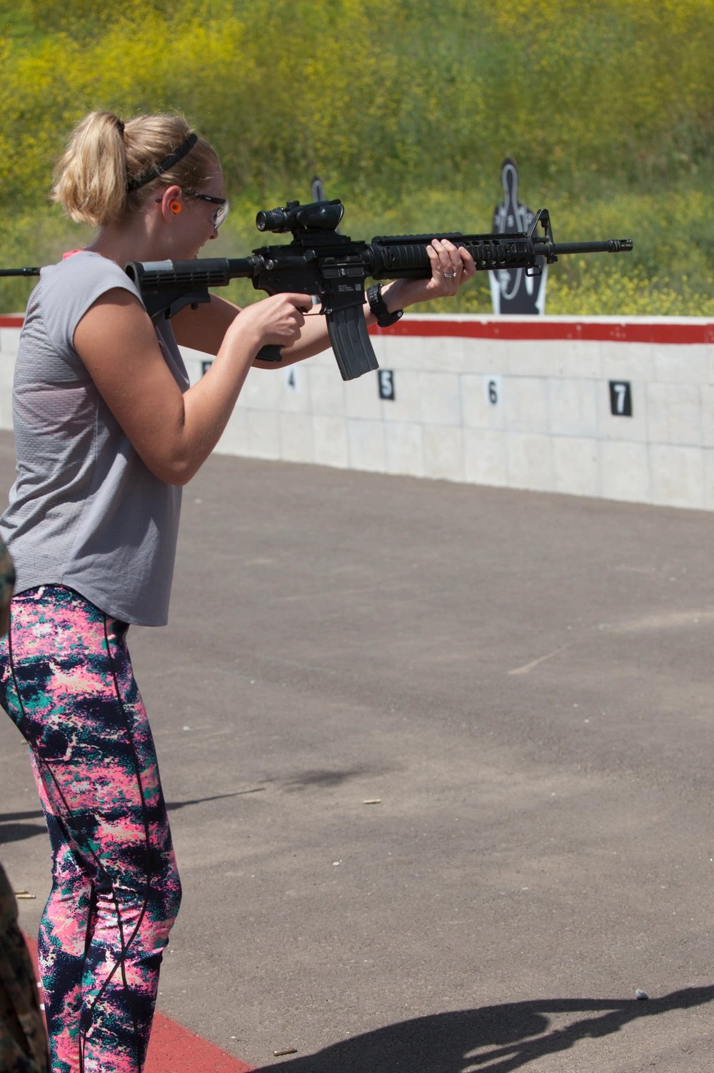 Mrs. Ellen Dehnhoff, participates in a live fire range at the shooting event during "J" Wayne Day, at Wilcos pistol range on Camp Pendleton, Calif., April 28, 2017. “J” Wayne Day is an event the spouses or loved ones have a chance to participate in multiple activities such as the Marine Corps Martial Arts, Pistol Range and the Fire Crash and Rescue followed by various demonstrations and displays. (U.S. Marine Corps photo by Lance Cpl. Rachel Mendieta)