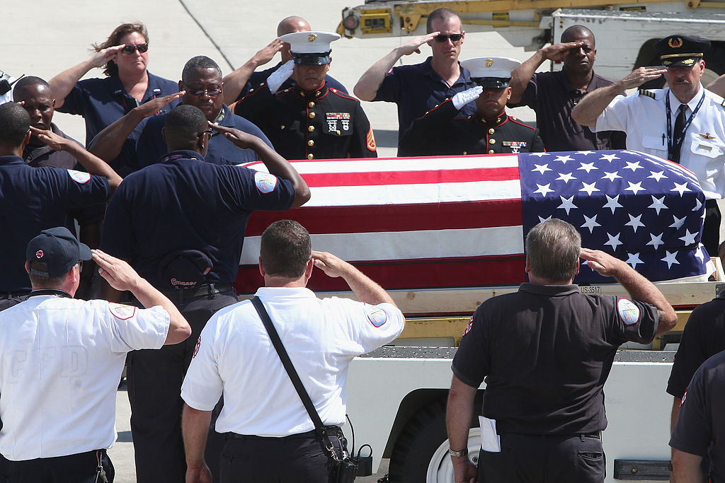 CHICAGO, IL - JULY 18: An honor guard composed of Marines, O'Hare flight crew, and family gather to accept the coffin containing the body of 24-year-old United States Marine Levy Rivera as it arrives on Delta Flight 1677 at O'Hare International Airport on July 18, 2013 in Chicago, Illinois. Levy was struck by a pickup truck on the Pali Highway on July 6 and later succumbed to his injuries. (Photo by Taylor Hill/Getty Images)