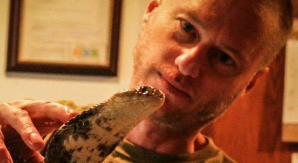 Tim Friede, whose antibodies underpin a new antivenom study, handles a water cobra during a supervised demo.